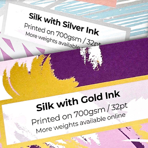 Close up comparison of silk business cards printed with metallic silver ink and metallic gold ink, showing 700gsm 32pt stock options.