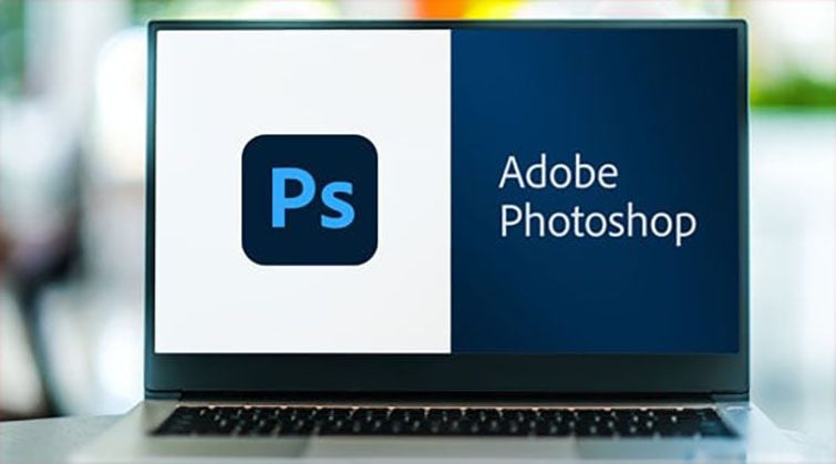 Adobe Photoshop logo displayed on laptop screen for professional photo editing and design