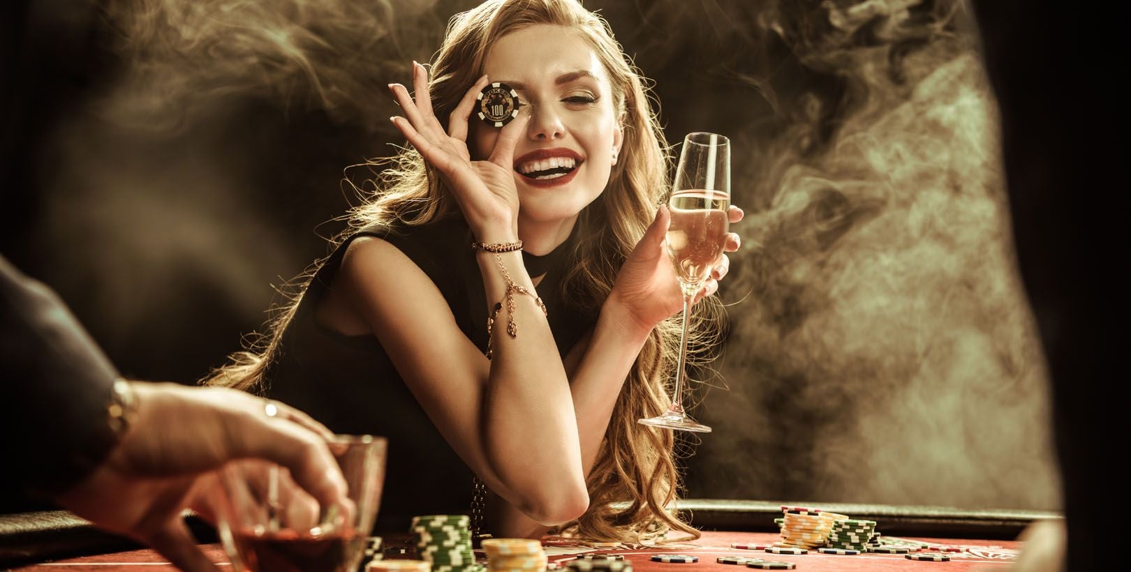 Woman holding poker chip and champagne glass celebrating casino gambling and party entertainment