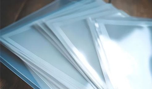 Clear protective card sleeves for trading card game storage and collectible preservation accessories