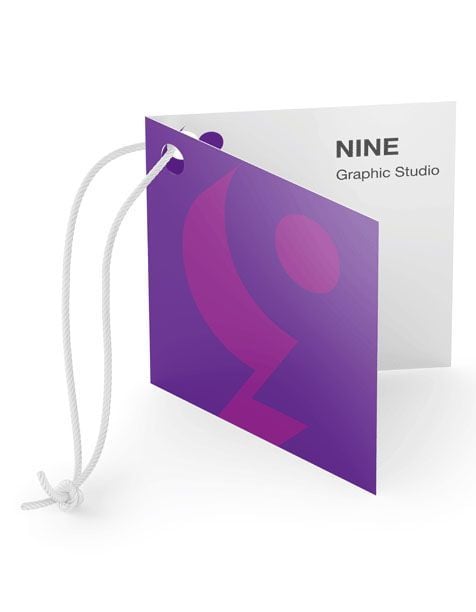 Folded product tag printing - Folded product tag with white string featuring purple geometric design and text reading NINE Graphic Studio.