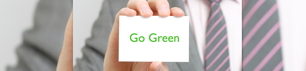 man holding a business card that says go green