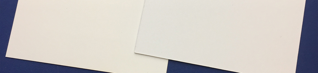 bright white card next to coated card