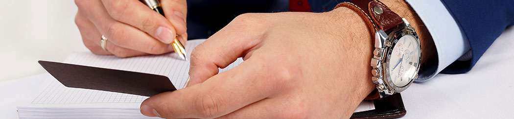 a man writing on a business card