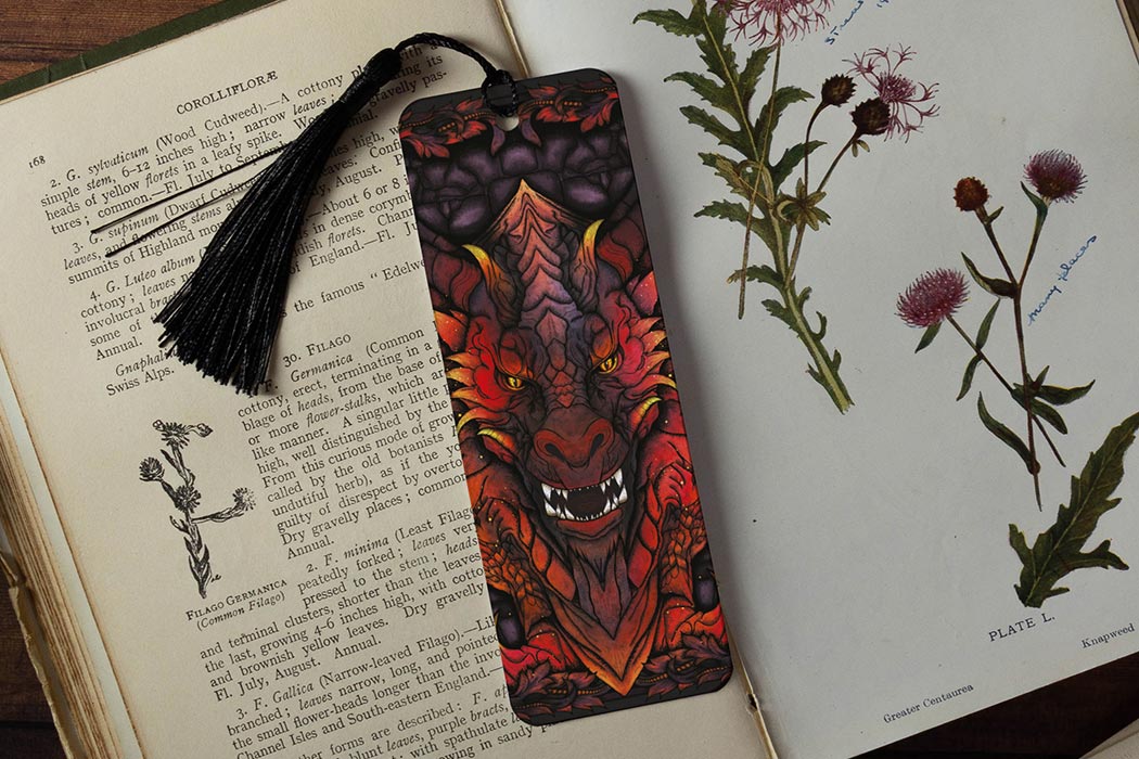 Red dragon bookmark on open book