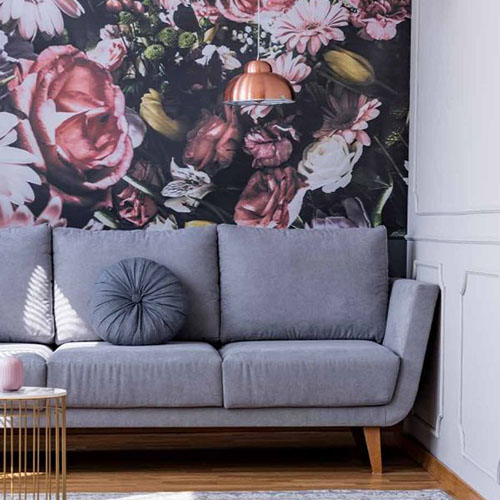 Botanical home wallpaper behind a living room sofa